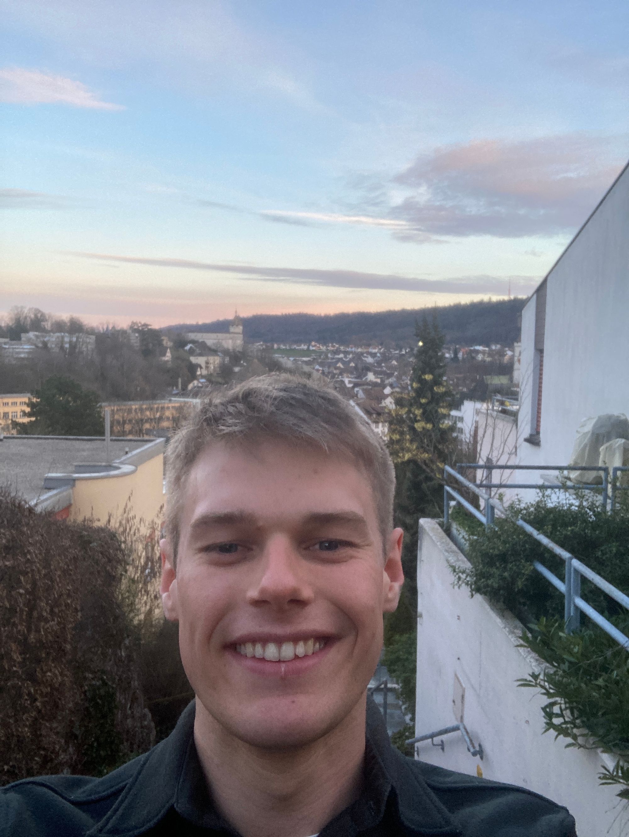Selfie of me (Oskar Eggert) with Schaffhausen in the background. You can tell sunset is not too far away by the sky.