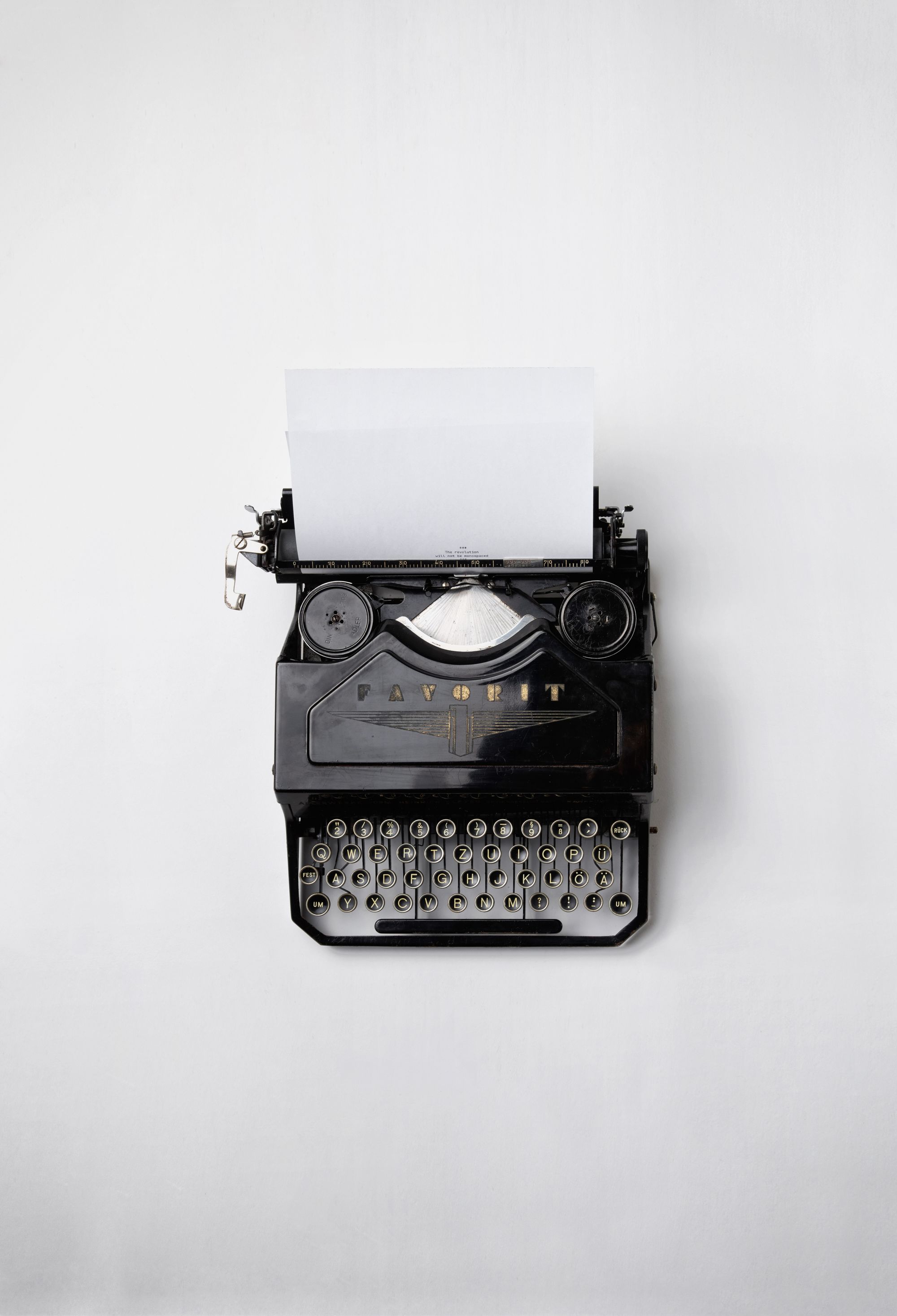 A typewriter on a white surface.