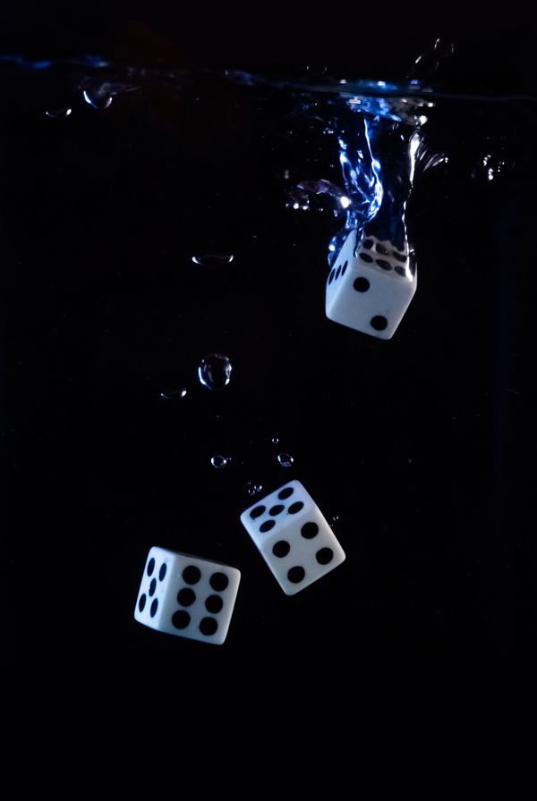 Three dices with a black background.