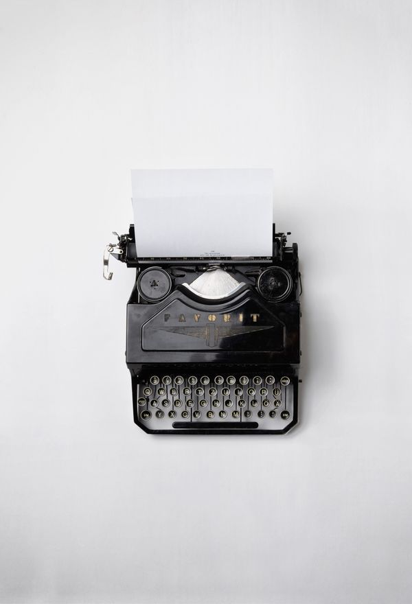 A typewriter on a white surface.